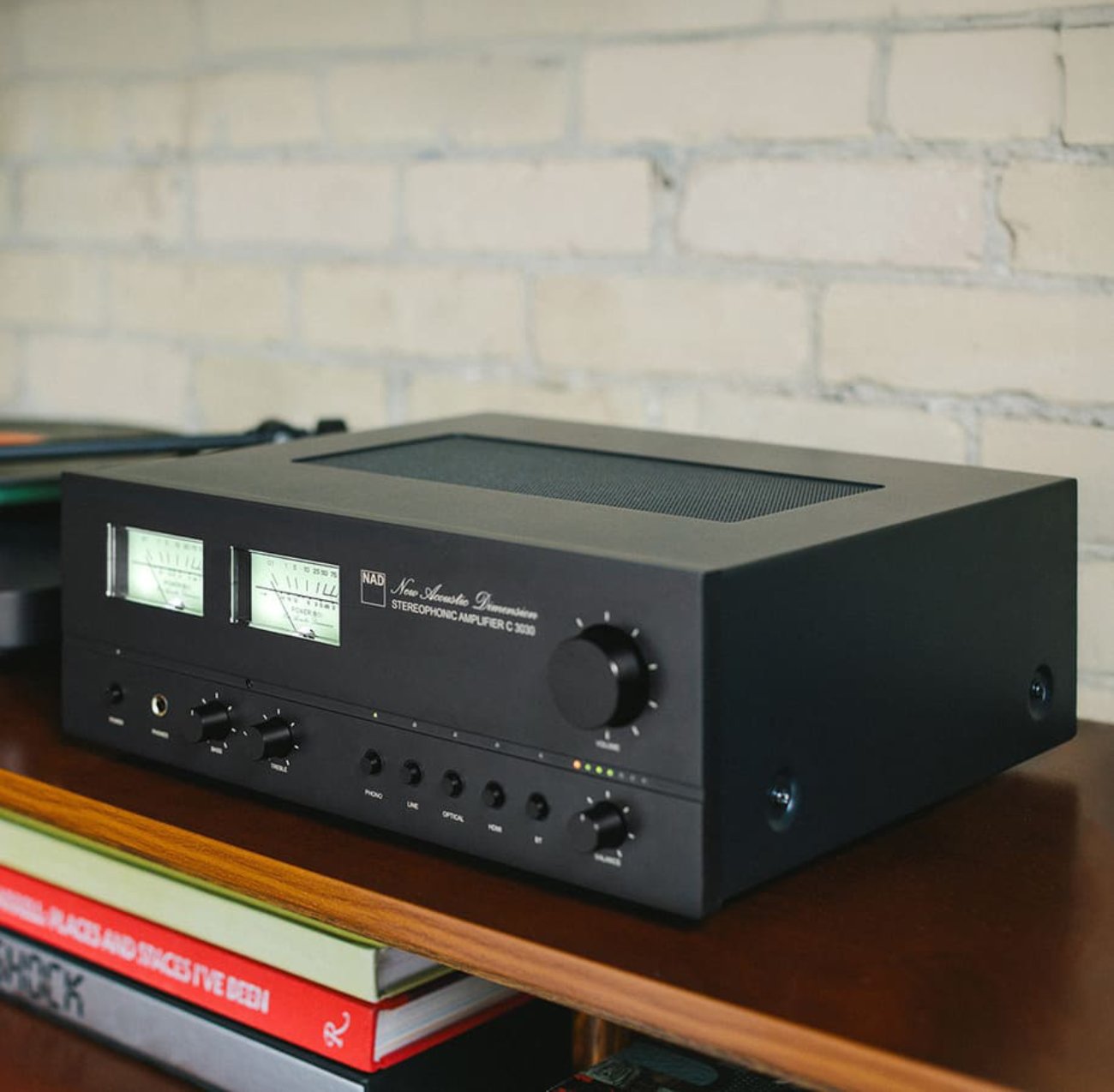 L’amplificateur NAD C 3030 vu de trois-quarts, mettant en valeur ses VU-mètres analogiques et son design néo-rétro.