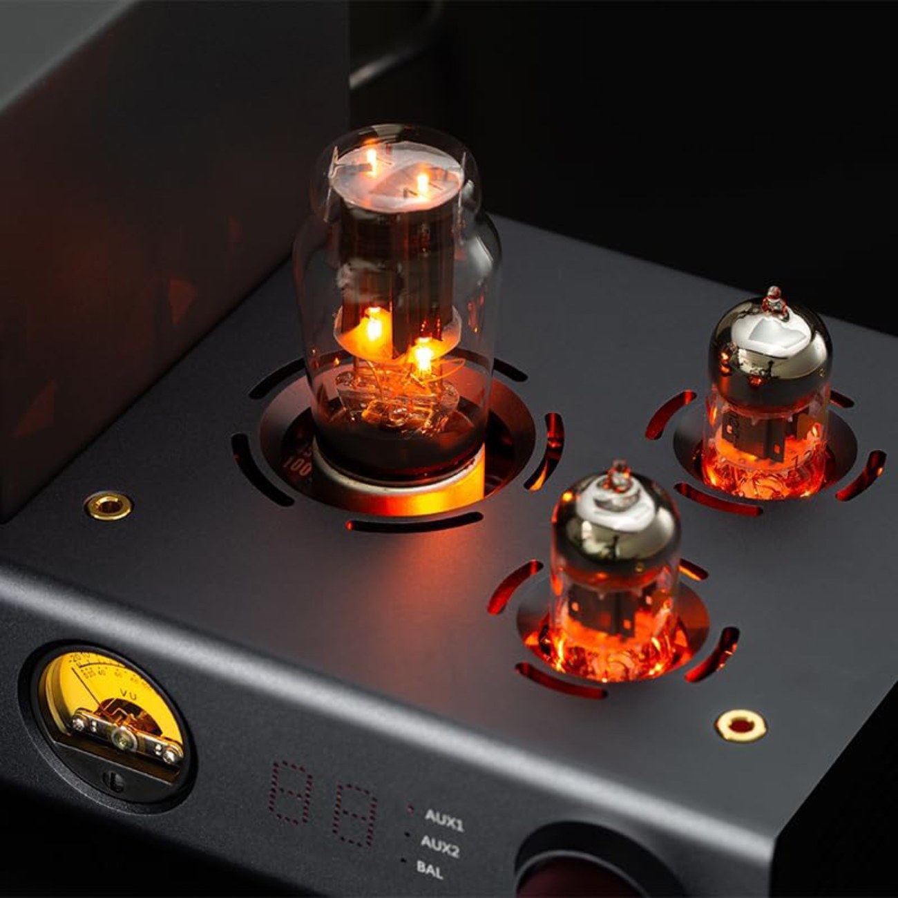 Gros plan sur les deux tubes de préamplification 12AU7 et le tube de rectification 5Z4P allumés sur le châssis noir du xDuoo TA-20 Plus.