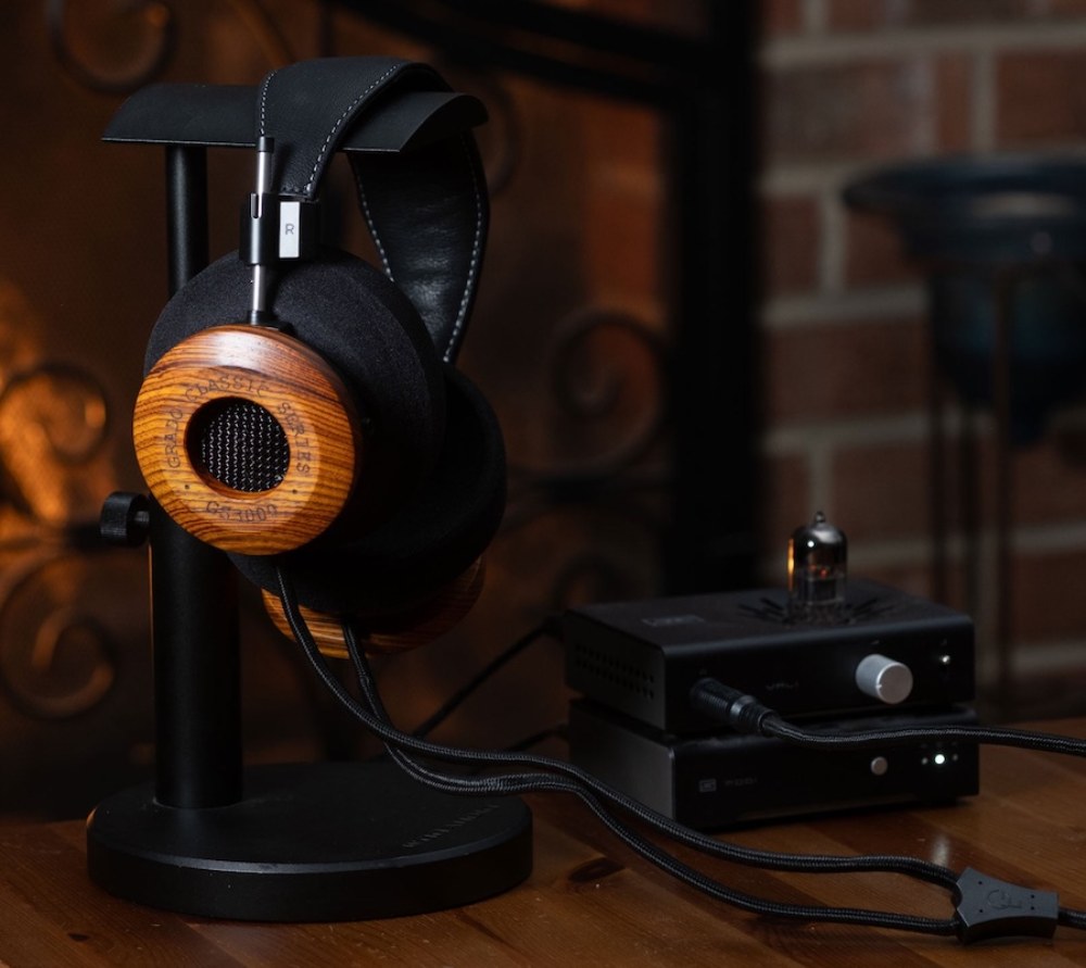 Casque Grado Classic Series GS3000 en bois de cocobolo sur support, connecté à un ampli casque à tubes, ambiance cheminée