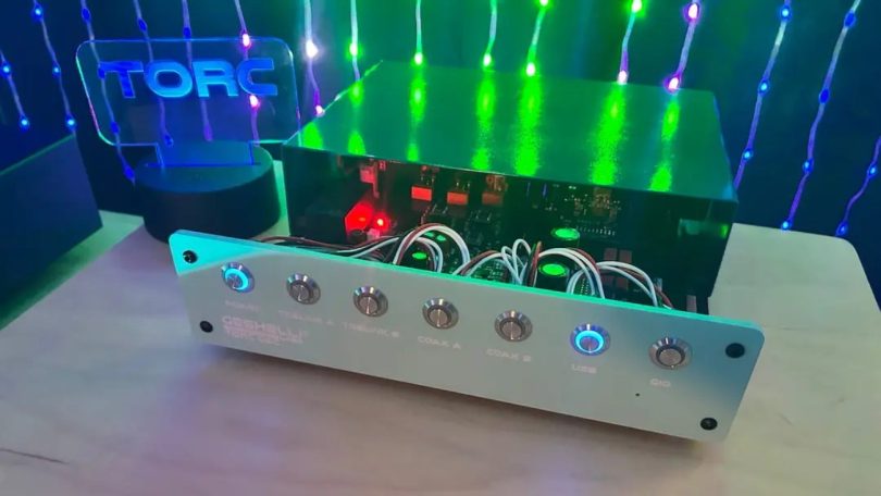 Geshelli TORC DAC ouvert montrant architecture modulaire, PCB, opamps socketed et câblage interne, façade argent avec boutons LED bleus