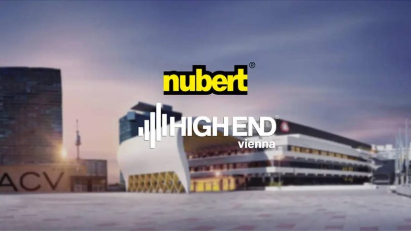 Visuel teaser officiel Nubert pour le salon High End Vienna 2026 : logos Nubert et High End Vienna superposés sur une vue de l'Austria Center Vienna (ACV) au crépuscule, lieu du salon hi-fi du 4 au 7 juin 2026