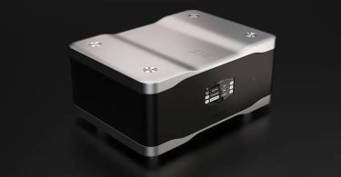 Convertisseur numérique-analogique Wadax Studio DAC au châssis noir et capot aluminium sculpté, écran de sélection de source affichant les entrées AES-EBU, RCA, BNC, Streaming, Akasa 2 et Transport, sur fond sombre