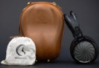 Casque planar magnétique ouvert Sendy Audio Apollo PRO à grille métallique sunburst et arceau noir, présenté avec son étui de transport rigide en cuir marron et sa pochette de rangement en chanvre