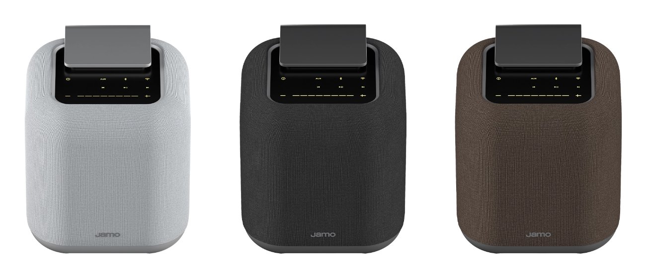 Les trois coloris de l'enceinte connectée Jamo HYG 5 vus de face : gris clair, gris foncé et Amber Dune, habillage tissu et dessus en aluminium