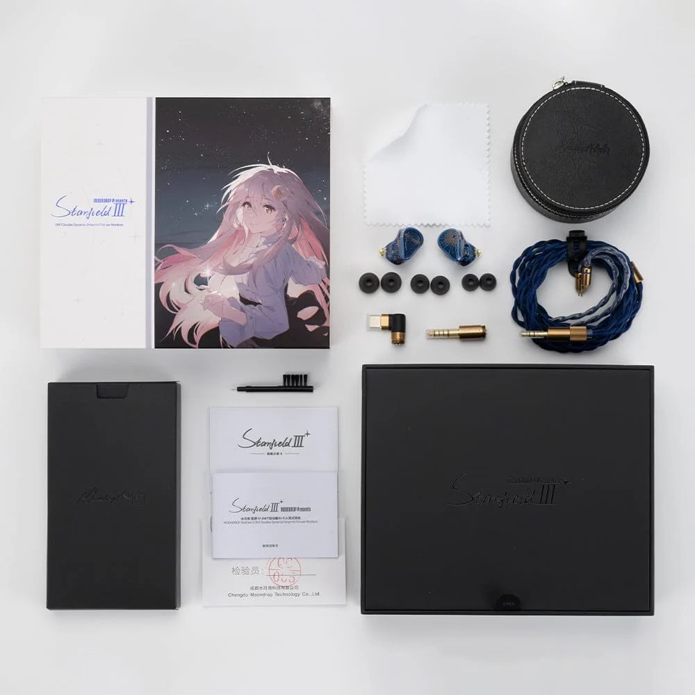 Déballage du Moondrop Starfield 3 : boîte et carte illustrée, étui de transport rond, écouteurs, embouts en silicone, câble tressé bleu, fiches interchangeables, chiffon et documentation